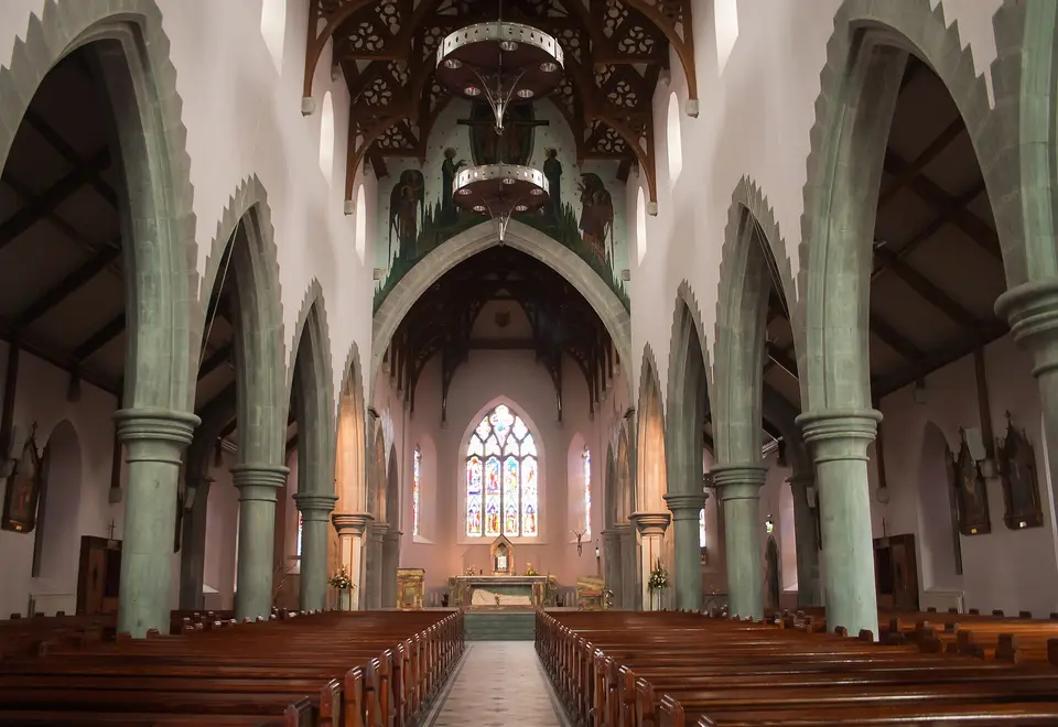 Nave of St. Michael's Church, looking south-east. The painting above the chancel arch depicts the Trinity and was created by Harry Clarke in 1924.