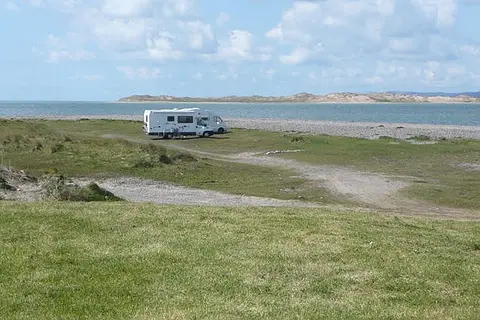 Campers on Cromane Beach Easy access to the beach from here, and there appears to be no constraint on taking your campervan closer. Inch Point beyond.