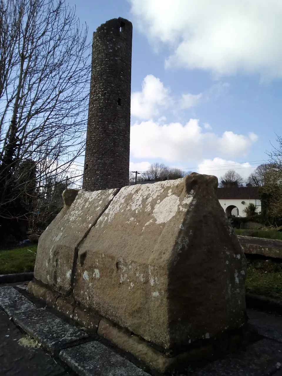 The medieval stone sarcophagus of St. Tigernach, and the round tower, at Clones, Co. Monaghan