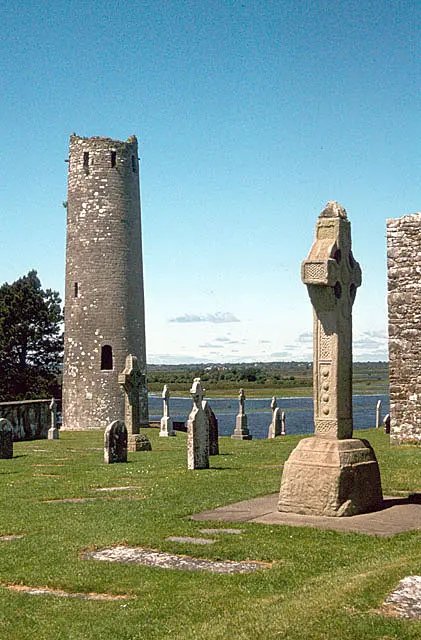 Clonmacnoise Crosses and the larger round tower in the precinct. The original crosses are now indoors; this view pre-dates the modern visitor centre.
