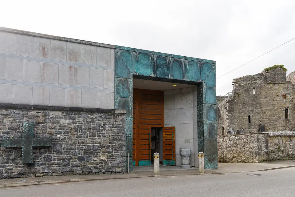 Entrance to St. Mary of the Rosary with the ruins of Cong Abbey in the background.