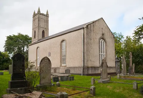 View from south-east of the simple tower-and-nave church.