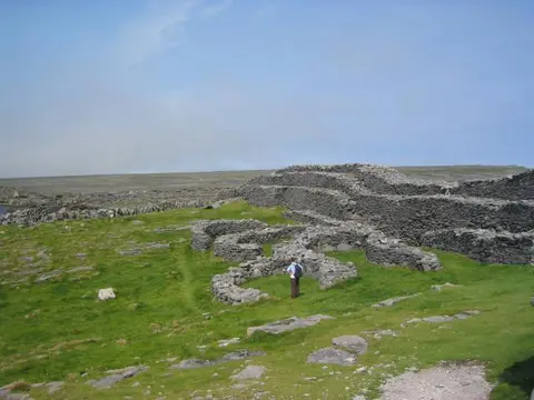 Dún Dúchathair. A promontory fort built in the Iron Age, containing the remnants of several "beehive" huts. The name means "black castle castle".