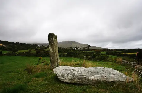 Farranamanagh Stone Row A row of three stones at Farranmanagh, two have fallen. The mist shrouded Rosskerrig mountain is behind.