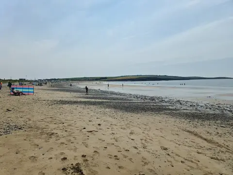 Garrylucas Beach on summer day with crowd of people enjoying the beach