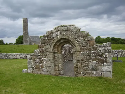 Holy Island (Inish Cealtra), Lough Derg, near Mountshannon in County Clare, Ireland. Ruins of St. Brigid's Church with Romanesque archway, St. Caimin's church in the background.