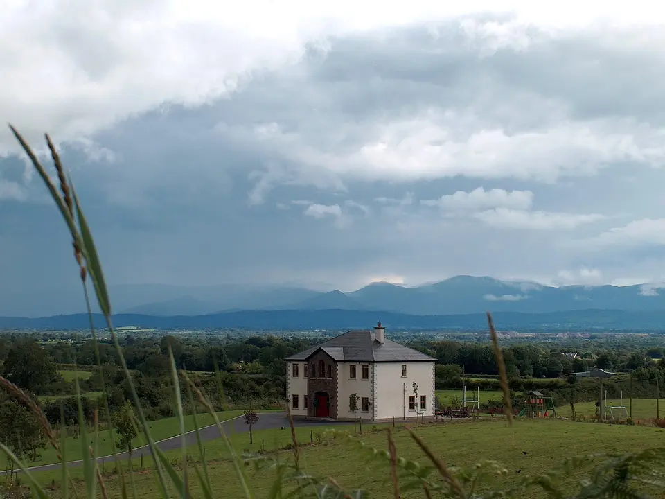 House at Moher East with distant view of the Galty Mountains