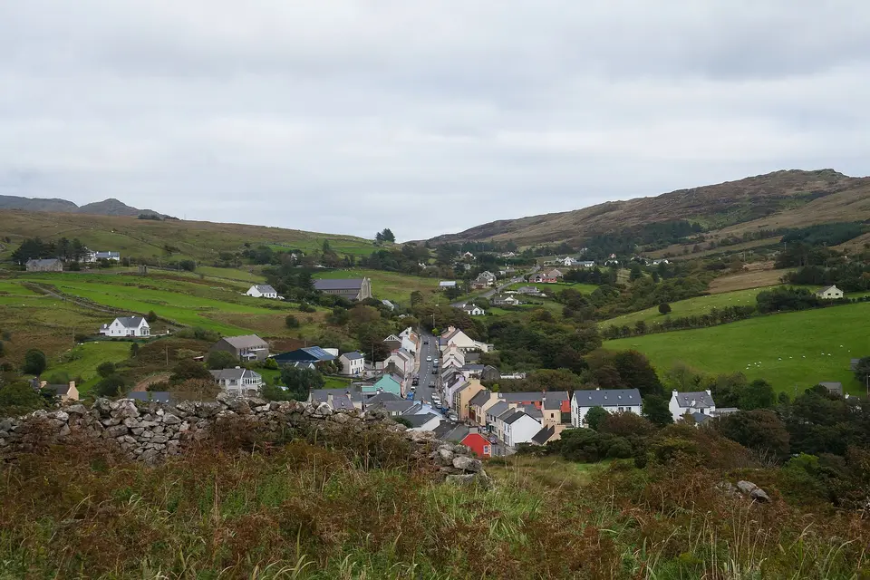 View from the monastic site at the old church down to the village, looking east. The R263 is to be seen as it leaves Kilcar in direction to Killybegs.