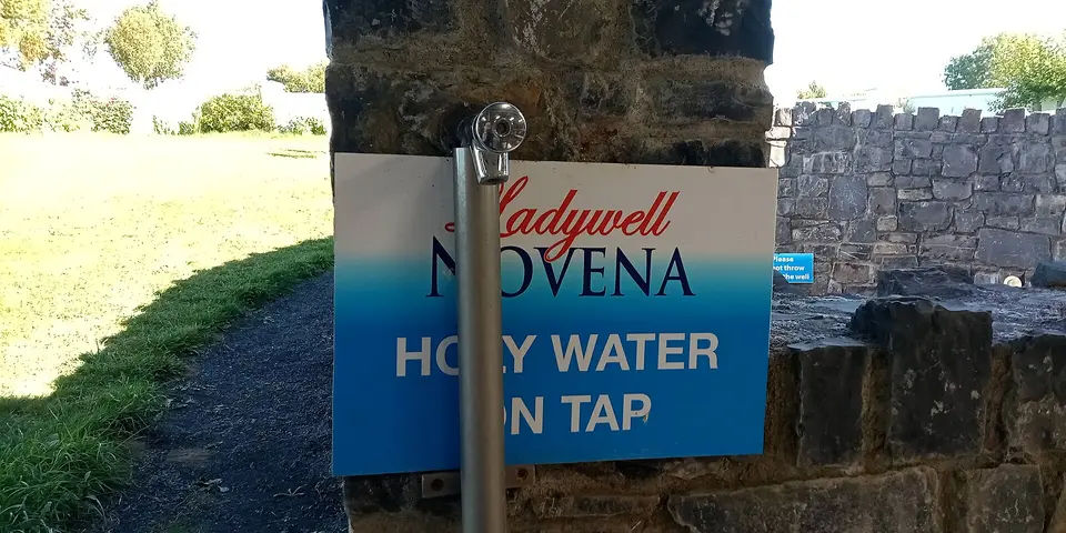 Holy water tap at Ladywell. Presumably for insurance reasons, the actual well is no longer accessible and covered with a grate.