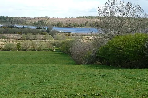 Loch an Rosa (Ross Lake) View of the lake across farmland from the N59.
