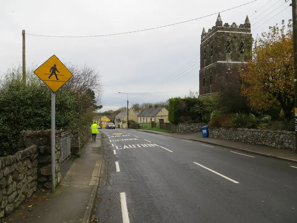 Main Street (R513) in Ballylanders near its derelict church