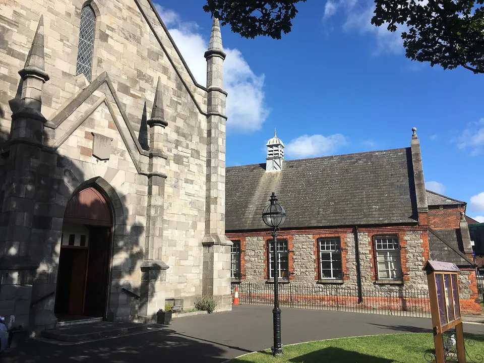 North Strand Church with infant's building of St. Columbas School in the background. The small green with a light and the notice board can also be seen.