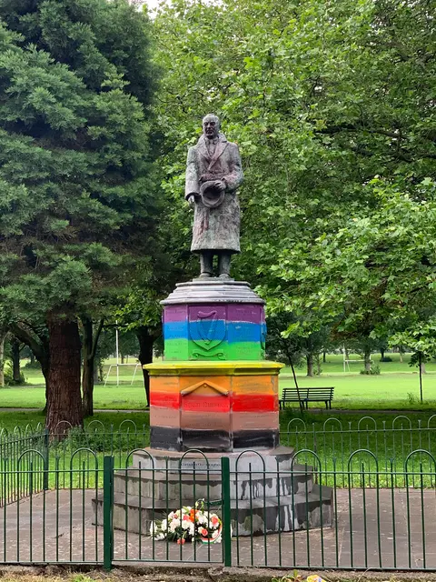 A photo of the Sean Russell statue in Fairview Park, Dublin, Ireland when it was painted with a rainbow base.