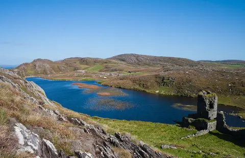 Lowest tower of Dunlough Castle in front of Dun Lough.