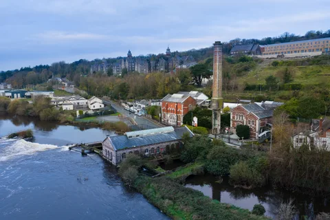 The old waterworks beside the River Lee, with the city rising behind it.