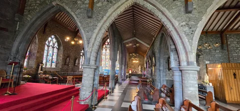 Stone arches and stained glass inside the Black Abbey.