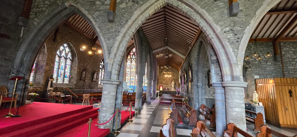 Stone arches and stained glass inside the Black Abbey.
