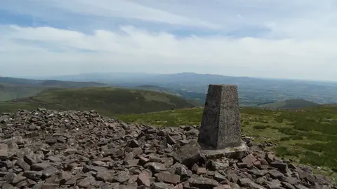 Trig point on Temple Hill with view towards Knockmealdown Mountains