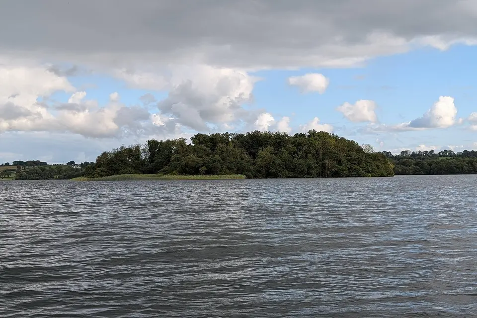 An image of Turgesius Island, the principal island on Lough Lene, viewed from the water.