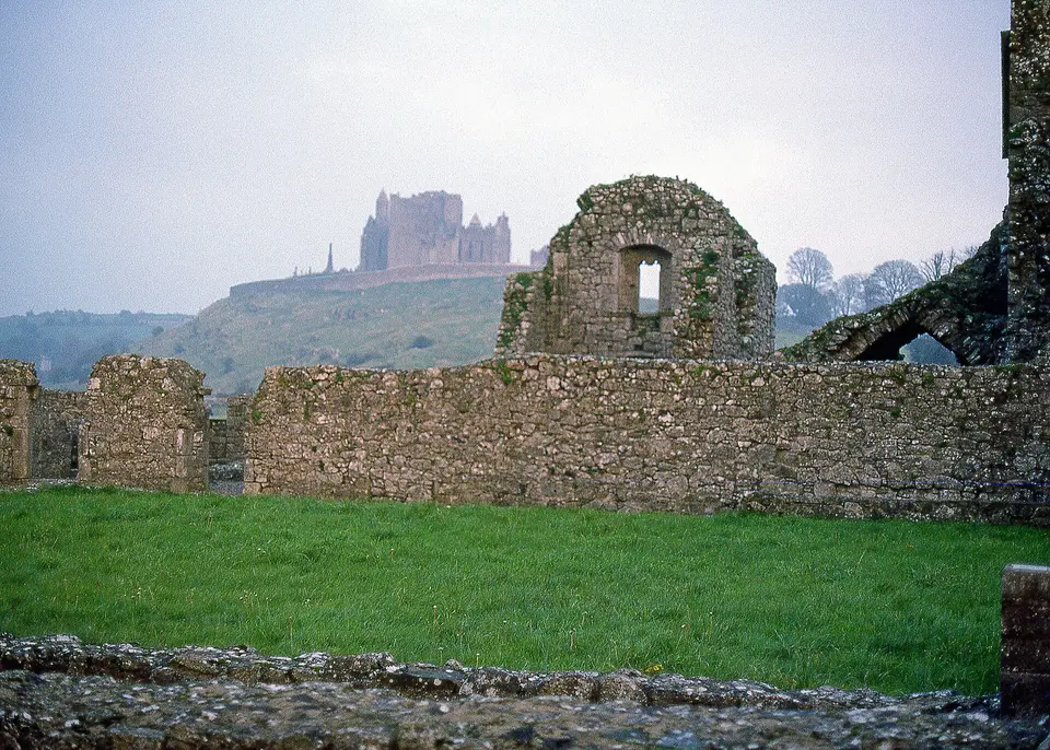 Rock of Cashel, with Hore Abbey in foreground. Photo by Peter Potter, sunset of October 31, 1987.
