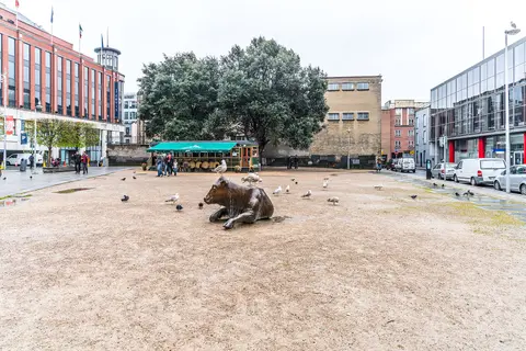 This statue is located at Wolfe Tone Square, Dublin, Ireland, beside the Jervis Shopping Centre. The gulls and pigeons are waiting to be fed.